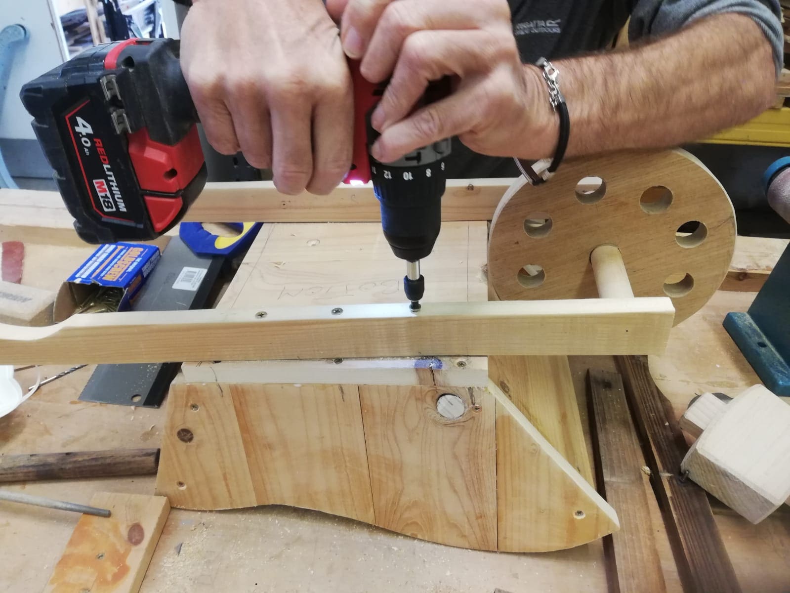 Man drilling screws into wood